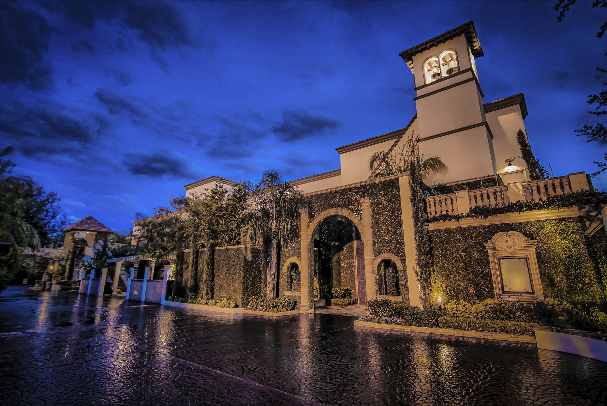 The Bell Tower on 34th exterior lit at dusk