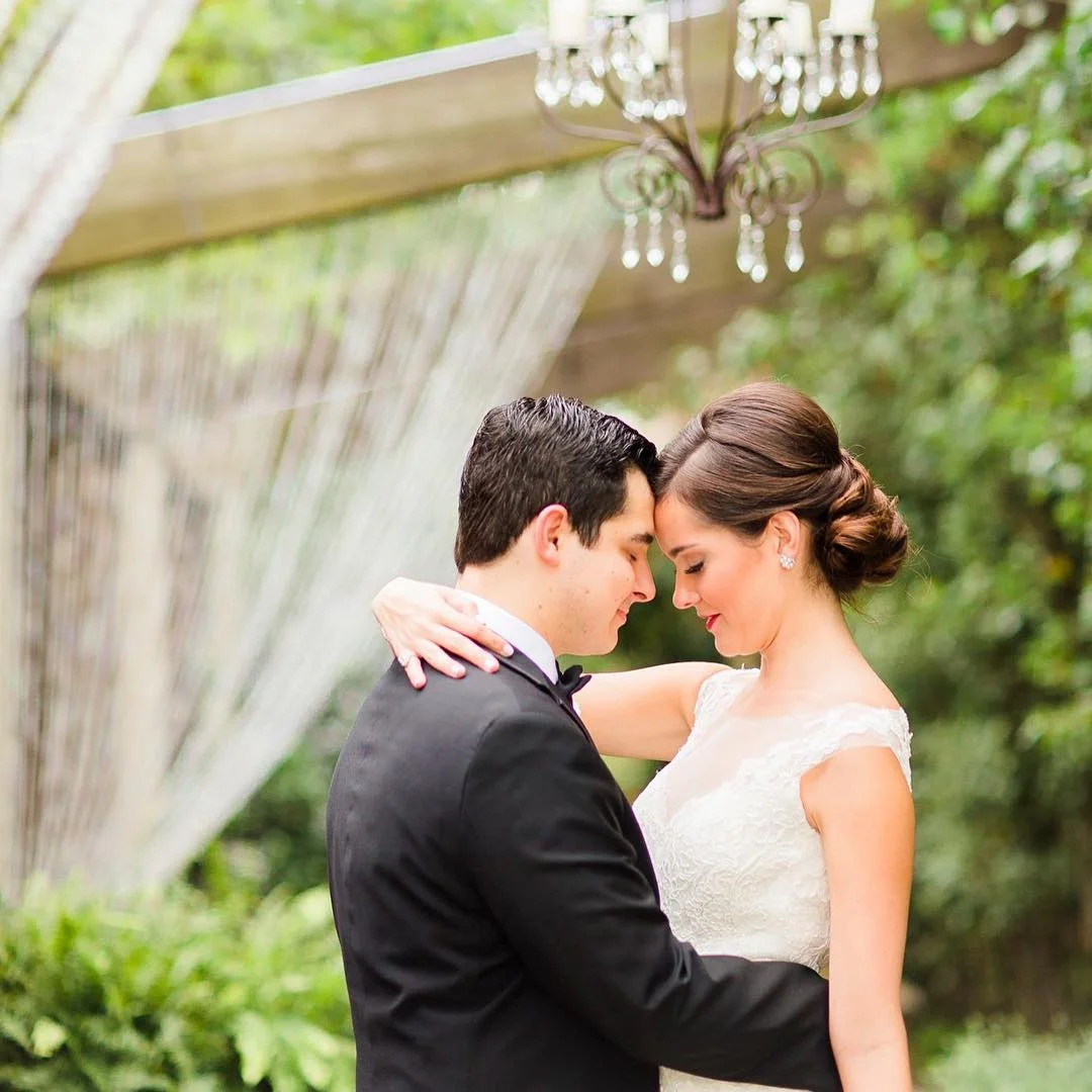 Bride and groom embrace in the Candela courtyard