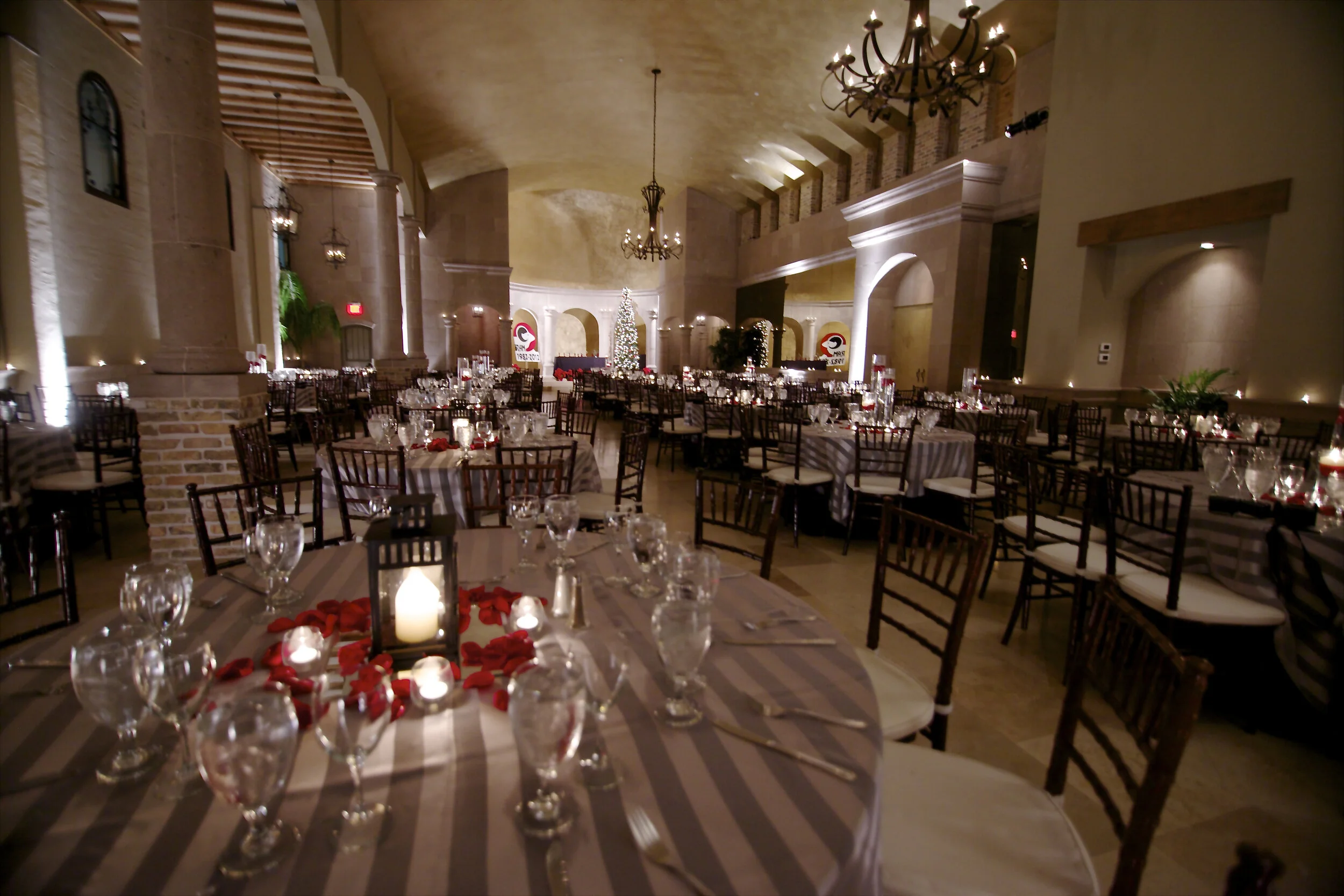 Candlelit corporate gala banquet beneath the chandeliers at The Bell Tower on 34th