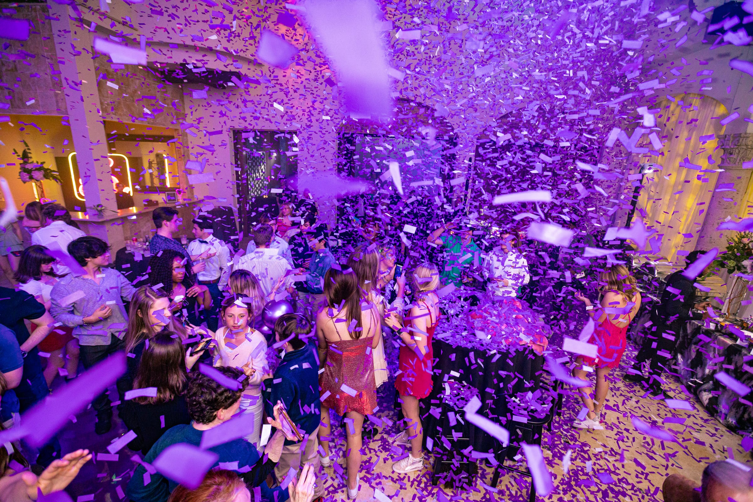 Guests celebrating on the dance floor under a confetti burst at The Bell Tower on 34th