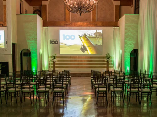 Conference seating facing a projection screen with uplighting at The Bell Tower on 34th