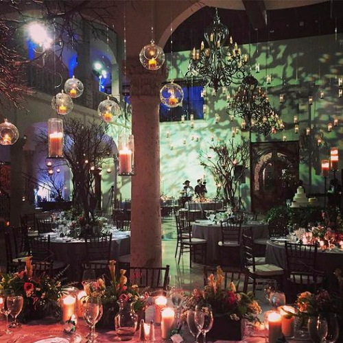 Candlelit themed celebration with hanging glass votives and round dinner tables at The Bell Tower on 34th