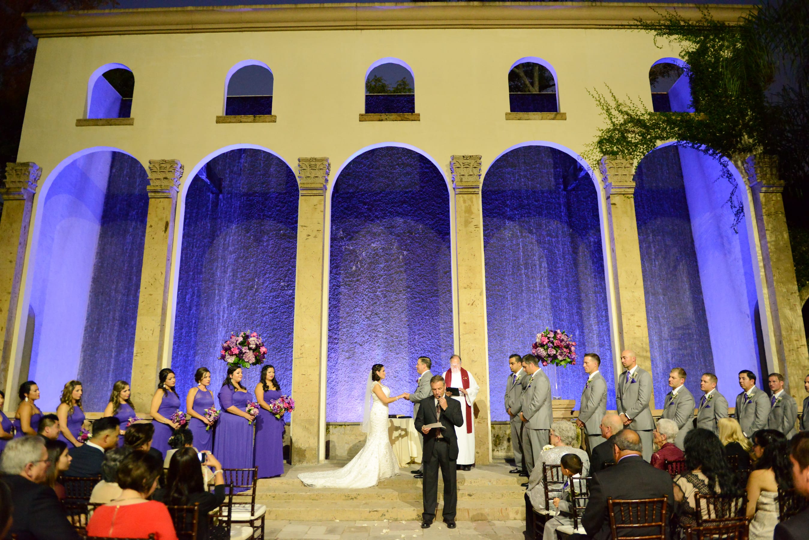 The Waterwall courtyard uplit at night for an evening event