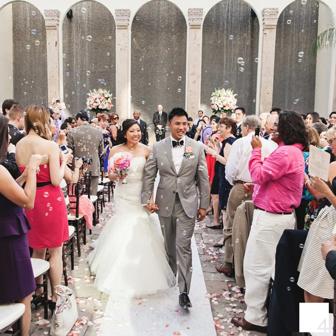 A ceremony produced by Event Producer Damaris De Leon at The Bell Tower on 34th, guests sending off the couple in a cloud of bubbles